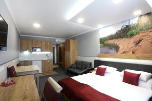 a hotel room with a bed and a kitchen at Hotel Strážnice in Strážnice