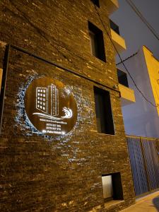 a sign on the side of a brick building at MavCity Boutique in Constanţa