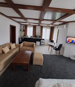 a living room with a couch and a table at Homely in Bansko