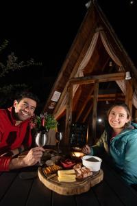 a man and a woman sitting at a table with food at DM El Refugio SG Af3 in Pinal de Amoles