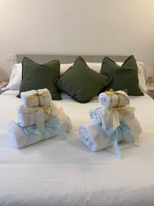 a white bed with towels and pillows on it at Stelle di Verona - Rigel in Verona