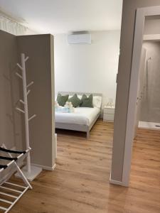 a bedroom with a bed in the middle of a room at Stelle di Verona - Rigel in Verona