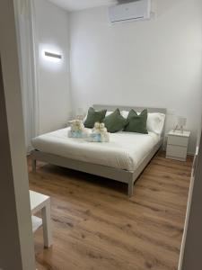 a white bed with teddy bears on it in a room at Stelle di Verona - Rigel in Verona
