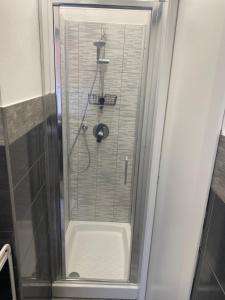 a shower with a glass door in a bathroom at Piccolo Paradiso in Novara