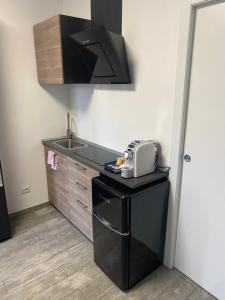 a small kitchen with a sink and a microwave at Piccolo Paradiso in Novara