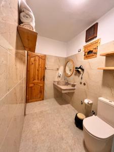 a bathroom with a toilet and a sink at deluxe experience siwa in Siwa +45 photos