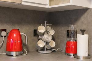 a kitchen counter with red appliances on a counter top at Lewis Living in Isle of Lewis