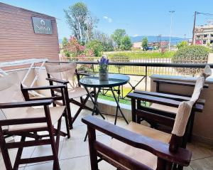 a group of chairs and a table on a balcony at Soso studios & apartments in Stavros