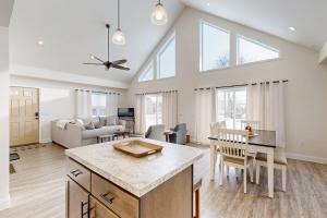 a kitchen and living room with a table and chairs at Schroon Lake Retreat in Schroon Lake