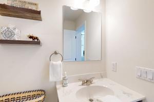 a white bathroom with a sink and a mirror at Schroon Lake Retreat in Schroon Lake +33 photos
