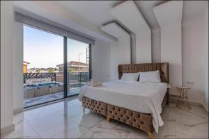 a bedroom with a bed and a large window at My Palace Villa Heated Pool in Belek