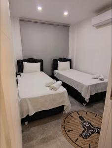 a room with two beds and a rug at My Palace Villa Heated Pool in Belek