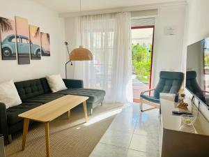 a living room with a couch and a table at Casa Heidi by Marena Homes in Playa del Cura