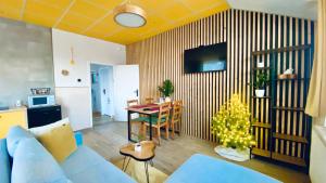a living room with a blue couch and a table with a christmas tree at Apartmány SVRČINKY in Liptovský Mikuláš