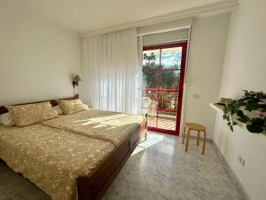 a bedroom with a bed and a window and a chair at Casa Heidi by Marena Homes in Playa del Cura +47 photos