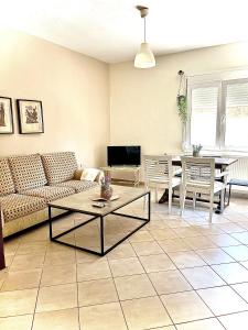 a living room with a couch and a table at Soso studios & apartments in Stavros