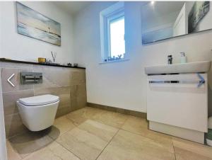 a bathroom with a toilet and a sink at Manor Brook House in Adare +11 photos