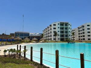 a large swimming pool in front of some buildings at Apartment with lagoon view mas amenities in Mazatlán