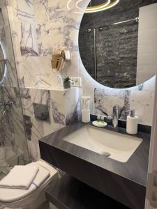 a bathroom with a sink and a toilet at MavCity Boutique in Constanţa