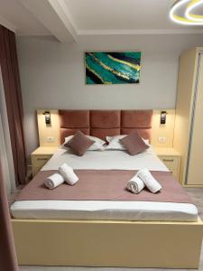 a bedroom with a large bed with three pillows at MavCity Boutique in Constanţa +31 photos