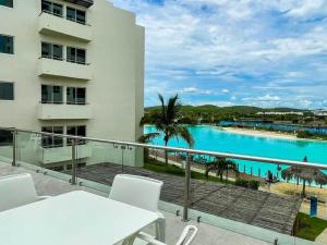 a balcony with a view of a swimming pool at Premium apartment in Laguna Playa with pool in Mazatlán