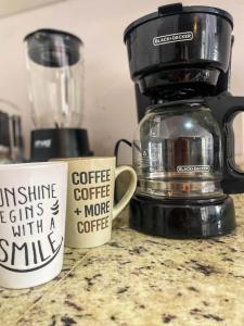 two coffee cups sitting on top of a counter at Premium apartment in Laguna Playa with pool in Mazatlán