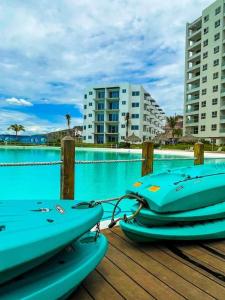 two kayaks sitting on a dock next to a pool at Premium apartment in Laguna Playa with pool in Mazatlán +38 photos