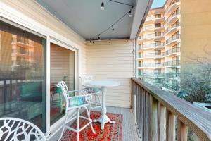 a patio with a table and chairs on a balcony at Sun Mark 253 in Ocean City
