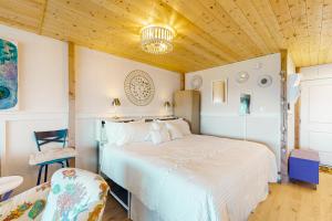 a bedroom with a large bed and a chair at Sun Mark 253 in Ocean City