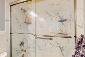 a bathroom with a shower with a glass door at Sun Mark 253 in Ocean City +6 photos