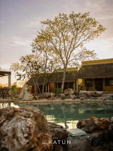a swimming pool in front of a house at Hotel Aldea Katún in Izamal