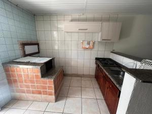 a tiled kitchen with a counter and a sink at Xangri-lá Beach House in Xangri-lá