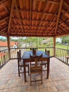 a wooden table and chairs on a patio at Pousada Chalés Jatobá in Prados