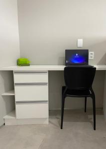 a desk with a laptop computer on top of it at Flat aconchegante em Recife in Recife +21 photos
