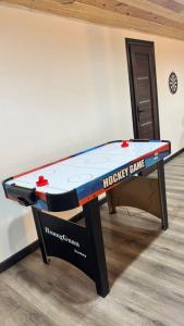 a ping pong table with a monopoly game on it at Prime House in Akunkʼ