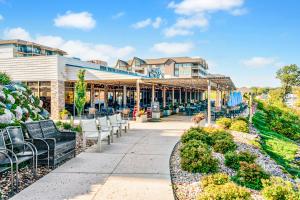 a patio at a hotel with tables and chairs at Bridges Bay Resort Bayside Building 203 in Arnolds Park