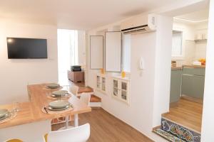a kitchen and dining room with a table and chairs at Don Sturzo Apartment in Caltagirone