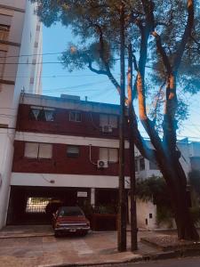 a building with a car parked in front of it at Olivos Stay in Olivos