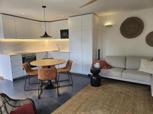 a kitchen and living room with a table and a couch at Blue Horizon Apartments in Varadouro