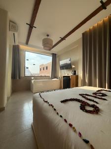 a bedroom with a large white bed with beads on it at Voyage On The Spot in Cairo