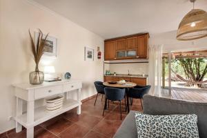a kitchen and living room with a table and chairs at Family & Friends Retreat w/ Pool - Moncarapacho in Tavira