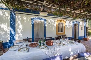 a table in a room with a white table cloth at Family & Friends Retreat w/ Pool - Moncarapacho in Tavira