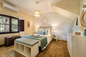 a bedroom with a large bed and a window at Family & Friends Retreat w/ Pool - Moncarapacho in Tavira