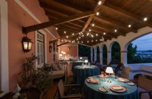 a restaurant with blue tables and chairs and lights at SOLO ! Charme Boutique in Avis
