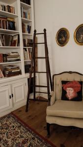a living room with a chair and a book shelf at SOLO ! Charme Boutique in Avis +7 photos