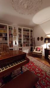 a living room with a piano and a couch at SOLO ! Charme Boutique in Avis