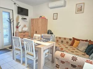 a living room with a table and a couch at CsakMiKisház in Harkány