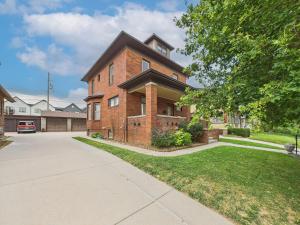 a brick house with a driveway in front of it at Casa Lentini in Omaha