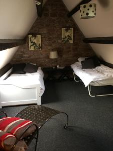 a attic room with two beds and a lamp at Lulus in St Bees
