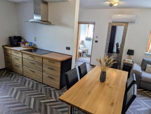 a kitchen and dining room with a wooden table at MY TIME BLED Holiday House with sauna in Zgornje Gorje